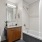 Bathroom with brown wood and small hexagon tile.