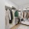 Spacious closet with clothes and small storage unit